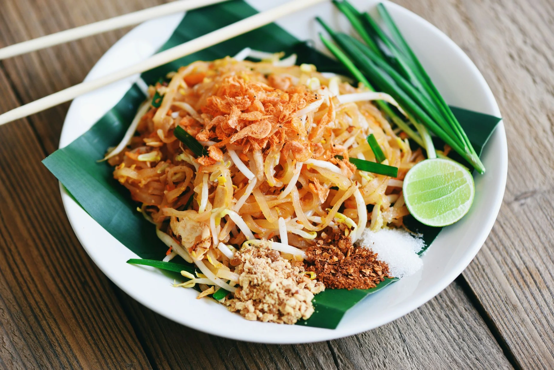 Stir-fry noodle Pad Thai on plate served on the dining table