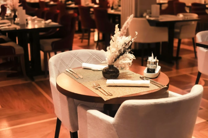A sophisticated restaurant interior with an intimate table setting,