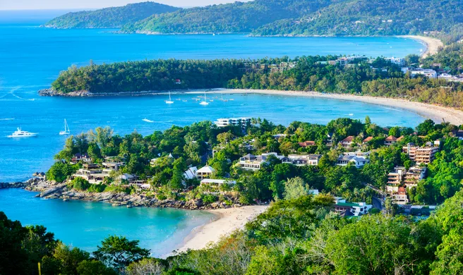 This scenic coastal view appears to show Kata Noi Beach, Kata Beach (Kata Yai), and the distant curve of Karon Beach, captured looking northward from the popular Karon Viewpoint in Phuket, Thailand.