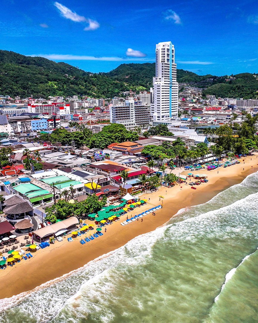 Patong Beach is the most famous and vibrant resort destination on the west coast of Phuket, Thailand, known for its lively three-kilometer golden shoreline, turquoise waters, and bustling urban backdrop.